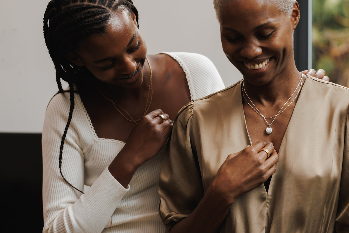 Mother and daughter exchanging holiday jewelry