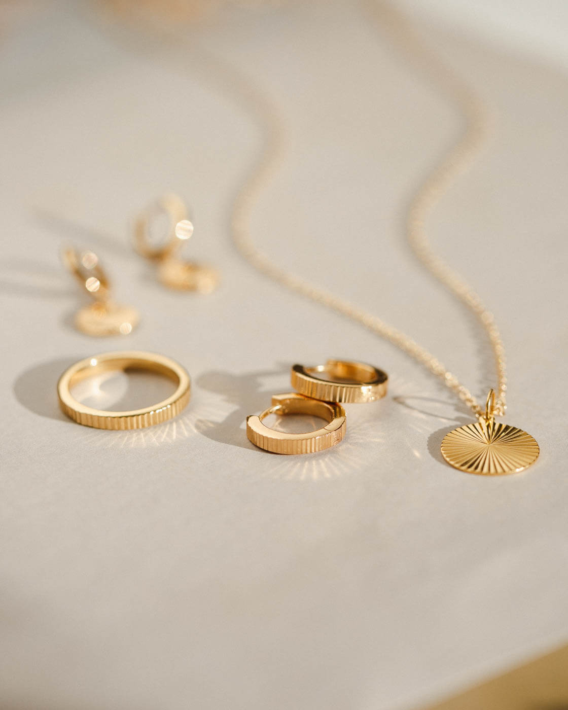 Radiant Charm Huggie Hoops — GLDN - Main Image